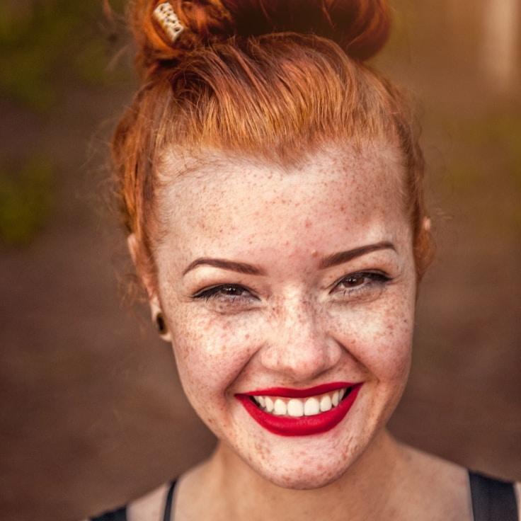 Kaveri Mehta, Lead Design Curator at GoldenBrookCove, reviewing corporate floral arrangements